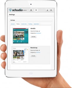 Schudio CMS settings page on ipad mini held in a hand