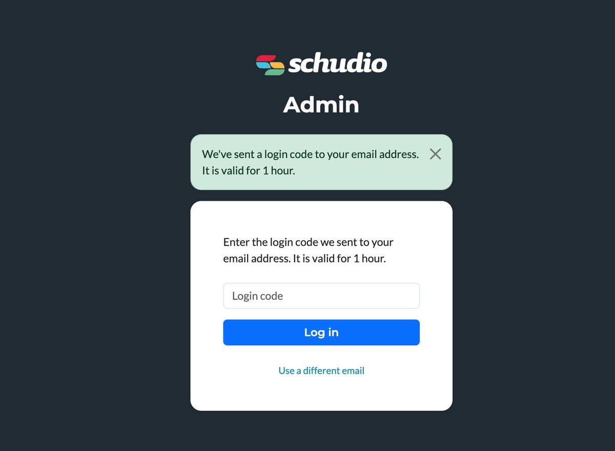 The Schudio Admin screen confirming a login code has been sent, with a Login code box, a Log in button, and a Use a different email link