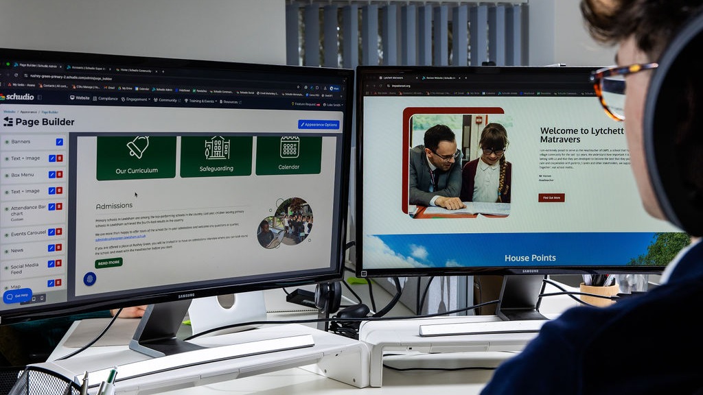 The Schudio CMS page builder open beside a live school website on a second screen, showing curriculum, safeguarding and calendar sections being kept up to date