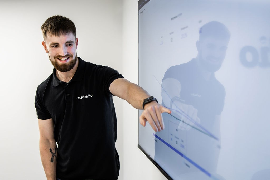 A member of the Schudio team reviewing pages on a school website on a large screen