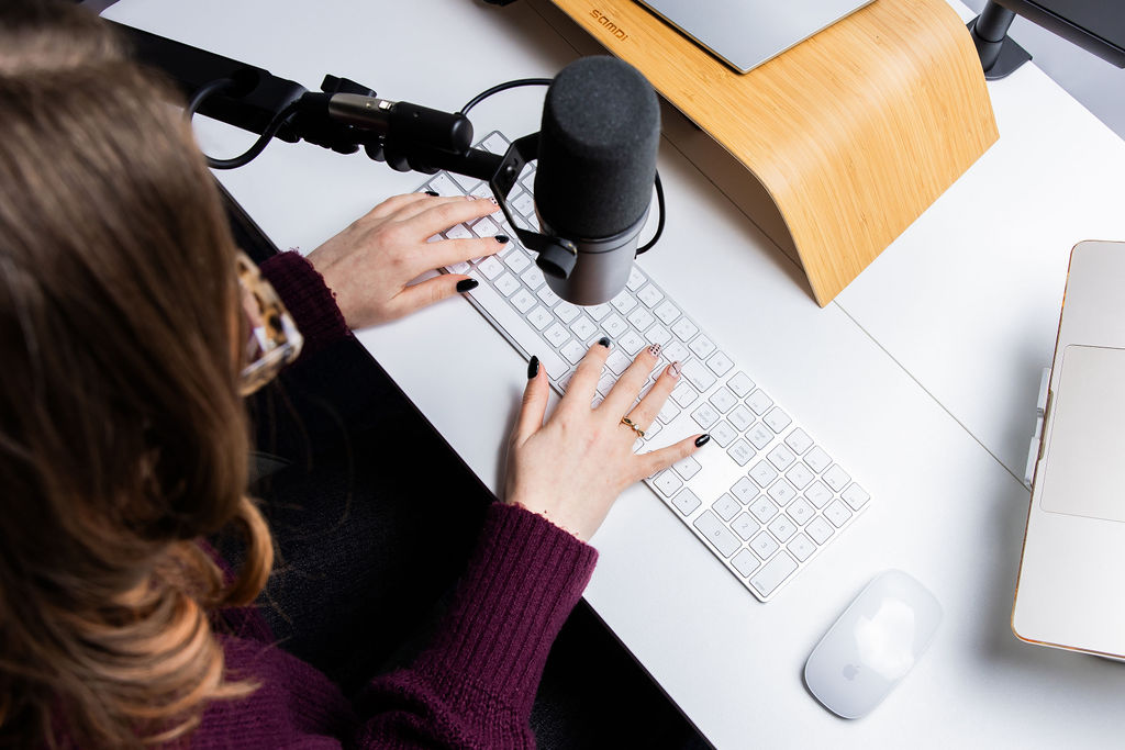 Overhead view of a Schudio team member typing at a keyboard while updating school website pages
