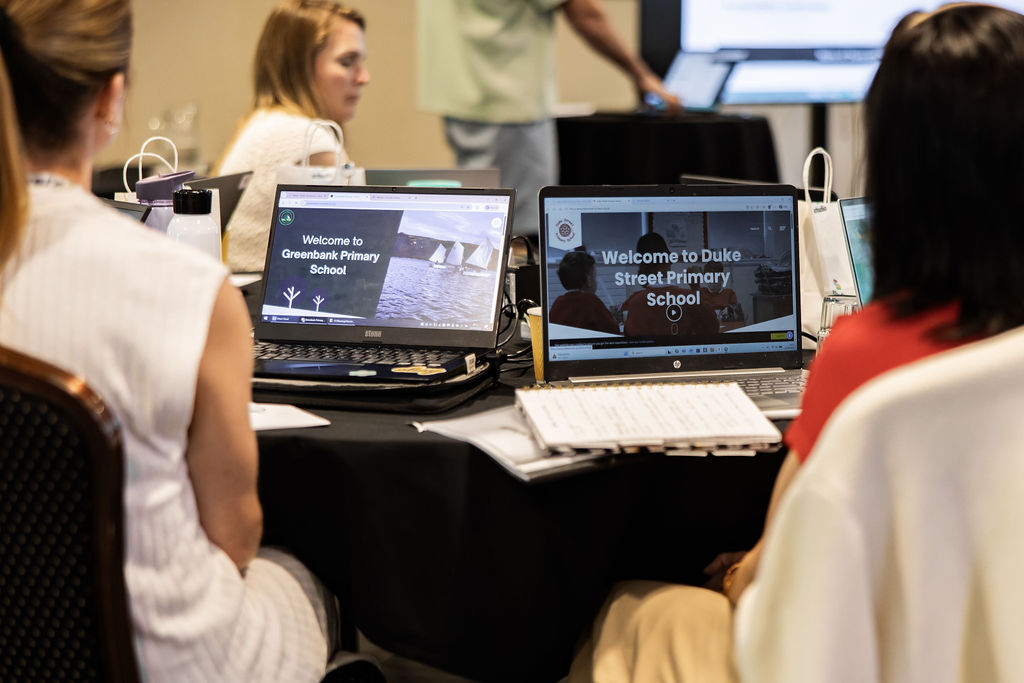 School websites open on laptop screens as staff review their content at a Schudio workshop
