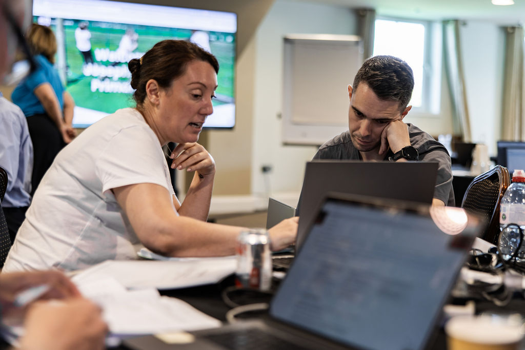 Two school staff members working together on website content at a laptop during a Schudio training day