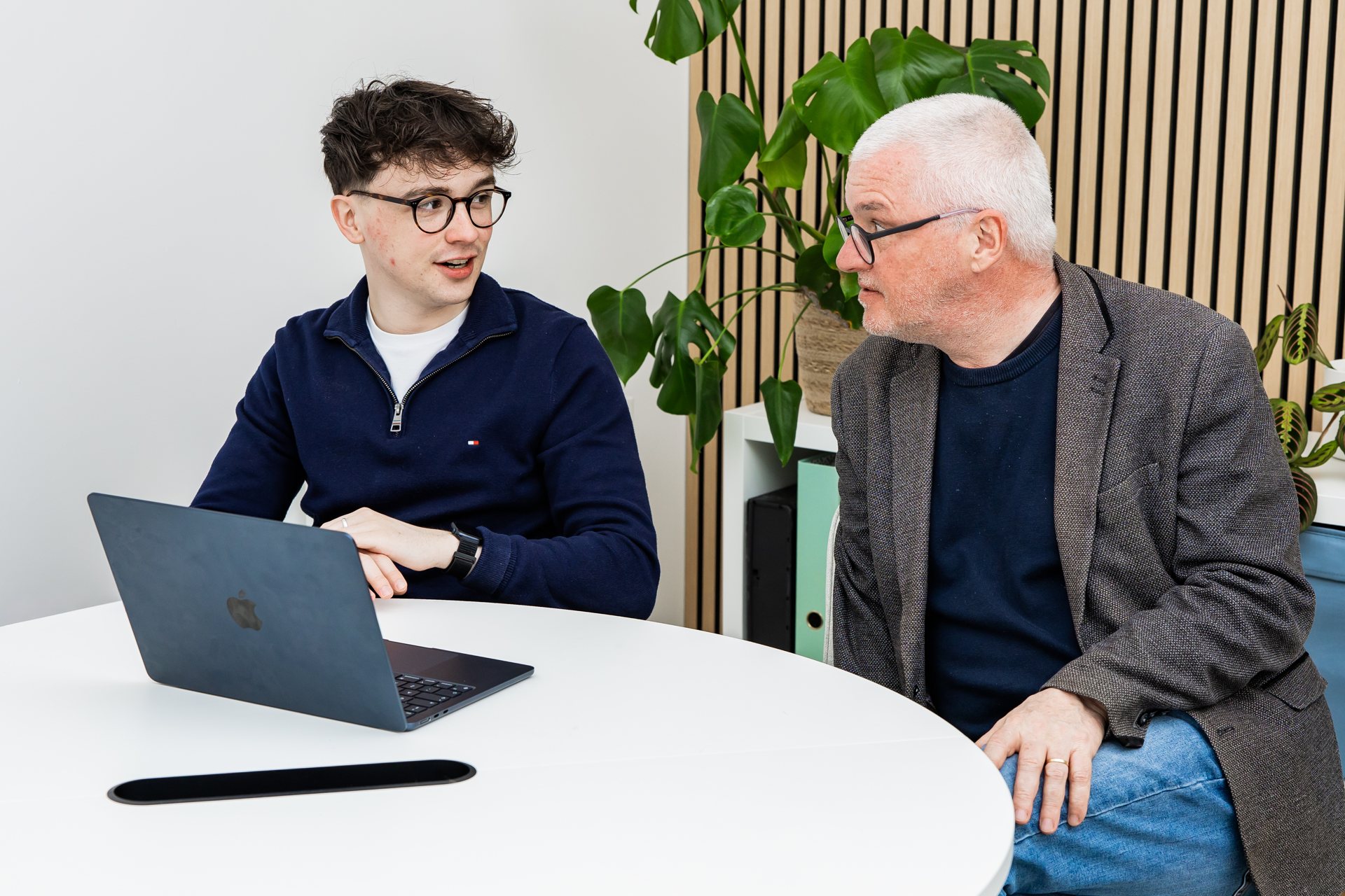 Two Schudio colleagues discussing a draft on a laptop before it goes live