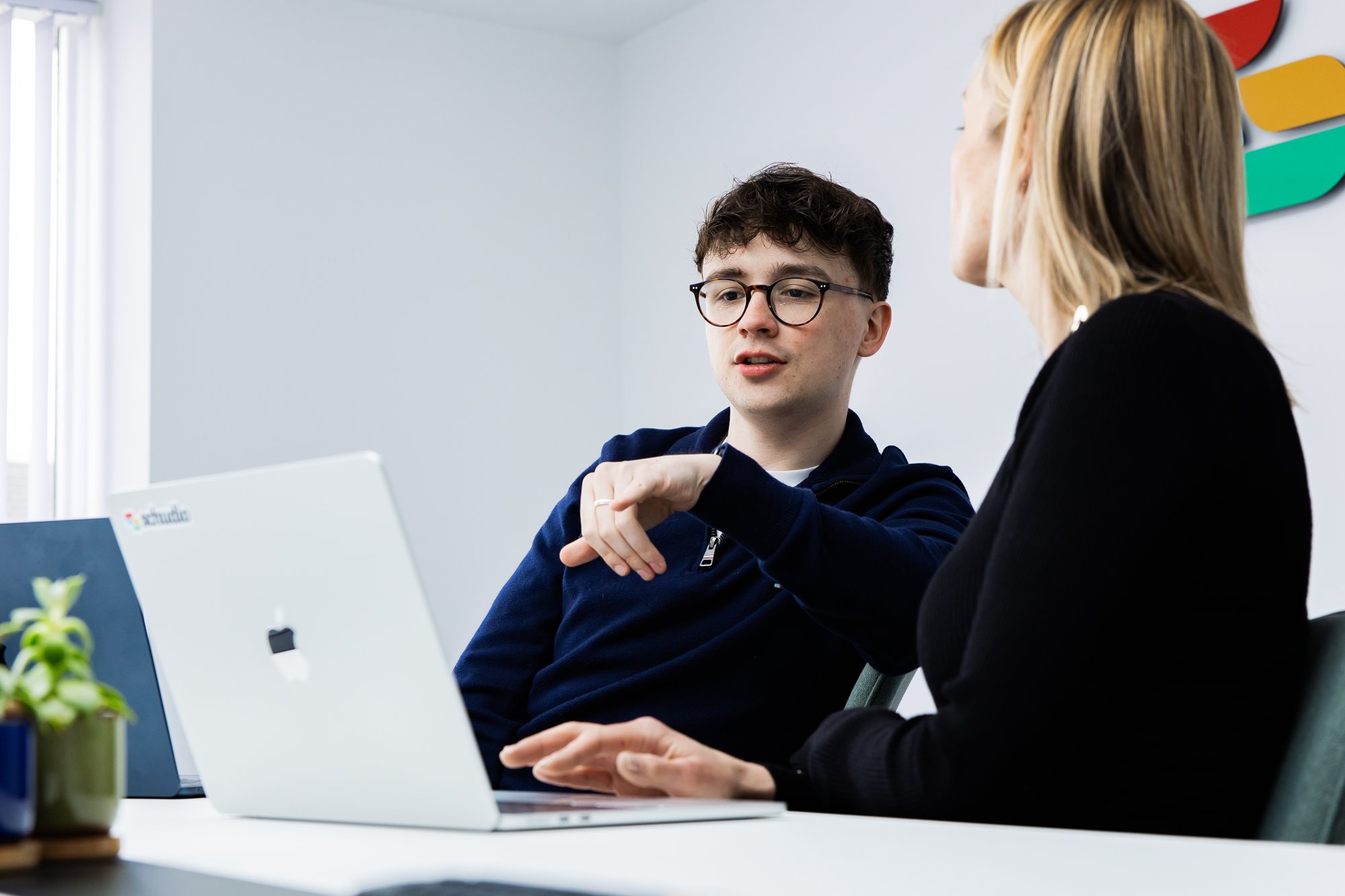 Two Schudio colleagues at a meeting table planning which school documents to turn into web pages