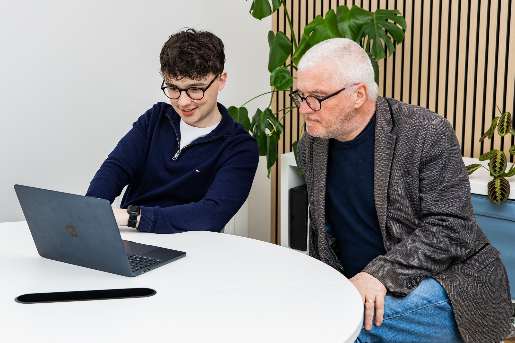 Two Schudio team members reviewing a school website compliance audit together on a laptop